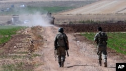 FILE - Turkish soldiers patrol near the border with Syria, east of Kilis, Turkey, July 24, 2015. Iraq has demanded Turkey remove troops from within its borders.