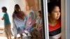 FILE PHOTO - Mariana Bulu, right, a former maid takes refuge at a temporary shelter for abused and mistreated maids before departing back to Indonesia at the Indonesian Embassy in Kuala Lumpur, Malaysia, Monday, July 2, 2007. (AP Photo/Marcus Yam)