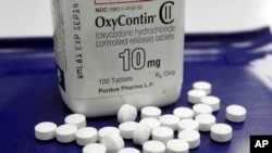 FILE: OxyContin pills arranged for a photo at a pharmacy in Montpelier, Vermont, Feb. 19, 2013.
