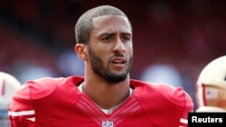 FILE - San Francisco 49ers quarterback Colin Kaepernick stands on the field before their NFL pre-season football game against the Denver Broncos in San Francisco, California.