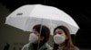 Passengers wearing masks to prevent contacting the coronavirus walk outside Seoul Railway Station in Seoul, South Korea, February 25, 2020. REUTERS/Kim Hong-Ji