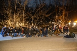 FILE - Greek Army soldiers detain a group of migrants that crossed from Turkey to Greece, near the village of Protoklisi, in the region of Evros, Greece, March 10, 2020.