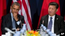 FILE - U.S. President Barack Obama, left, has directly discussed concerns about China's pending anti-terrorism law with the country's leader, Xi Jinping. They're shown during a meeting in Paris, Nov. 30, 2015. 