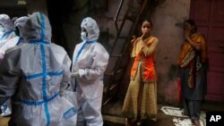 Health workers screen residents for COVID-19 symptoms at Dharavi, one of Asia's biggest slums, in Mumbai, India, Aug. 3, 2020. India is the third hardest-hit country by the pandemic in the world, after the United States and Brazil.