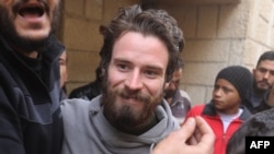 Travis Timmerman, a U.S. citizen who entered Syria from Lebanon on a Christian pilgrimage and was detained for several months, speaks with reporters in a house in Damascus on Dec. 12, 2024, after he was found in the village of Thihabiyeh.