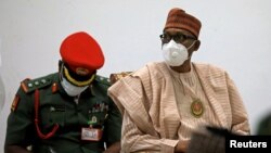 Nigerian President Muhammadu Buhari looks on after security forces rescued schoolboys at the Government house in Katsina, Nigeria, Dec. 18, 2020.