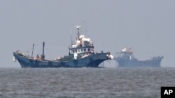 FILE - In this photo provided by the South Korean Defense Ministry, Chinese fishing boats are seen in neutral waters around Ganghwa island, South Korea, June 10, 2016. 