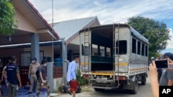 In this photo released by the San Sai District Administrative Office, journalists working for Democratic Voice of Burma, prepare to get into a van after being arrested at San Sai District in Chiang Mai province north of Thailand Sunday, May 9, 2021…