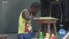 Ivorian Painter With No Arms or Legs Makes Art -- and A Living
