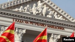 FILE - National Macedonian flags flutter in front of the government building in Skopje, Macedonia, June 12, 2018.