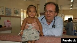 Dr. Beat Richner holds a baby at Kantha Bopha children hospital, in Phnom Penh, Cambodia. (Courtesy photo) 